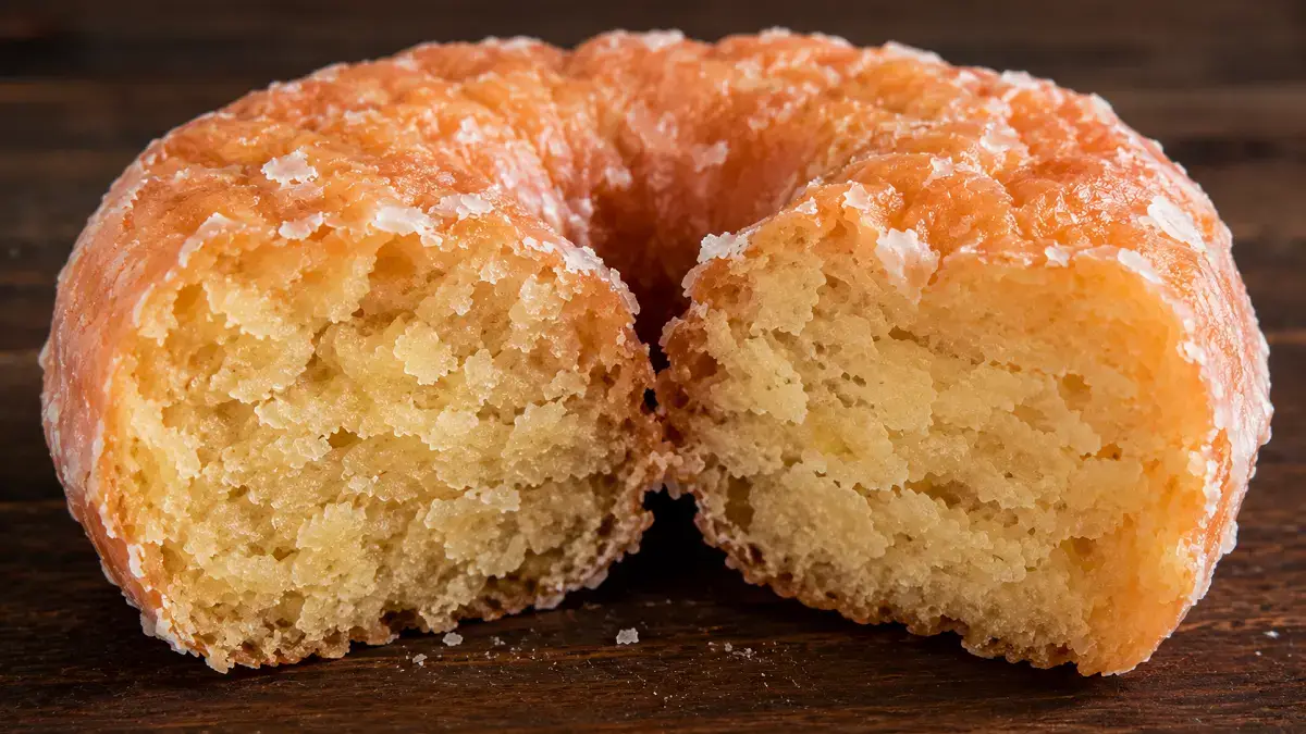 Cross-section of an old fashioned donut showing dense cake-style crumb