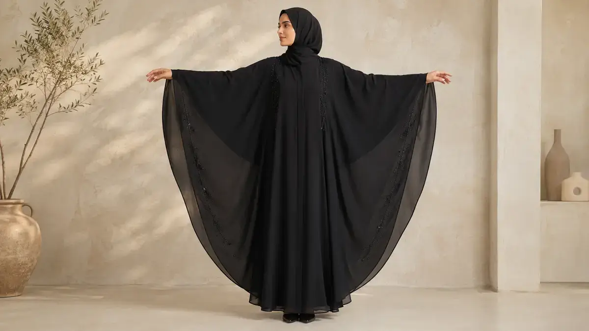 Woman wearing black butterfly abaya with wide flowing sleeves